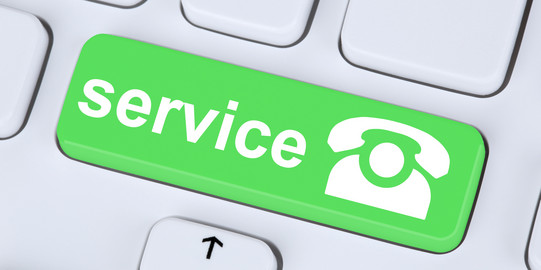 A white keyboard with one green key. A telephone and the word „service“ are printed on it